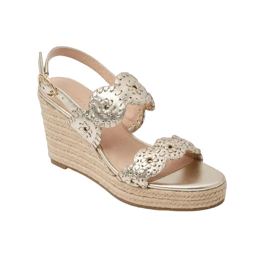 Gold wedge sandal with decorative straps on a white background