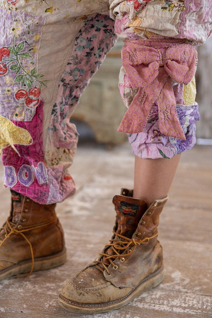 Magnolia Pearl artisan patchwork pants with floral prints, pink bow, vintage boots, whimsical style