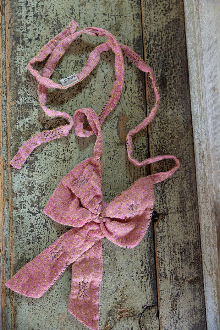 Magnolia Pearl artisan pink patterned jacquard bow tie on rustic vintage wood surface