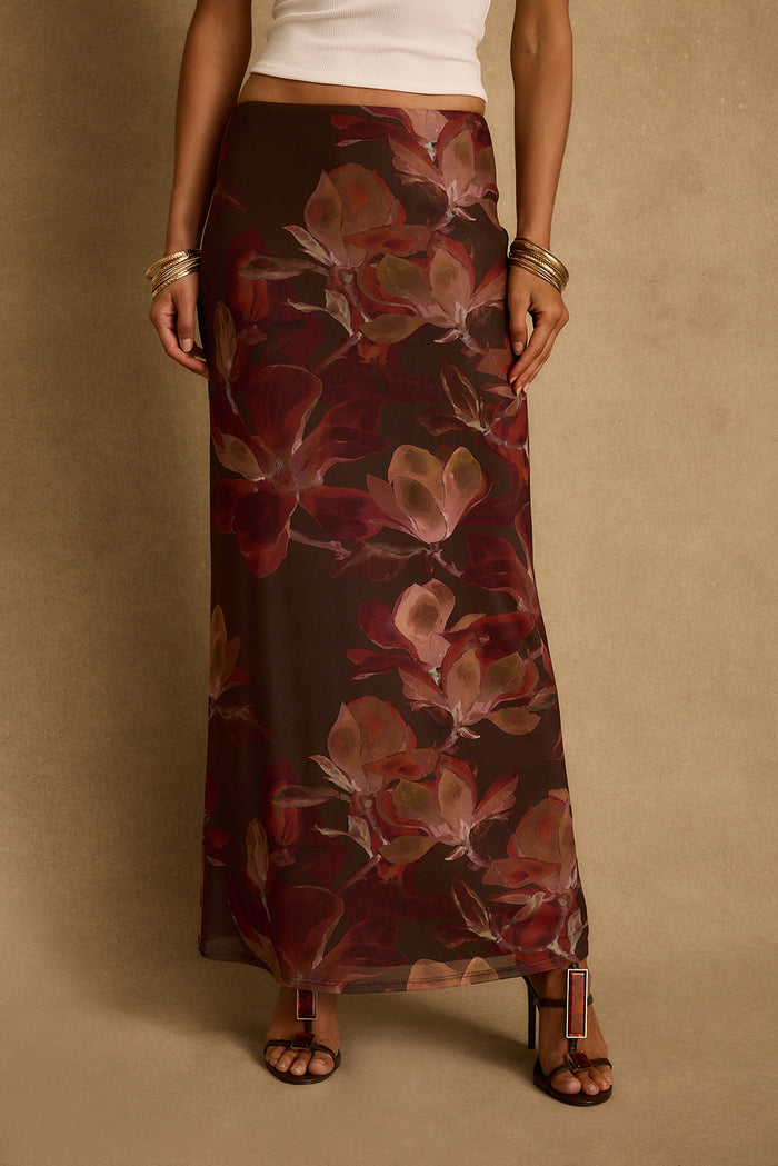 Cropped view of the Julia mulberry floral mesh maxi skirt styled with white tank and gold bangles.