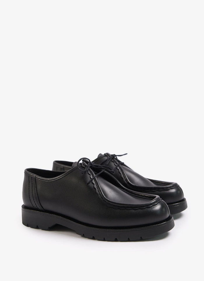 A pair of black leather Kleman Padror shoes from Percival with a serrated hem detail and a thick rubber sole.