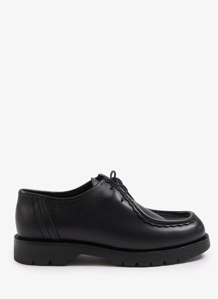 Side view of the Percival black leather Kleman Padror shoe with its distinctive stitching and chunky rubber sole.