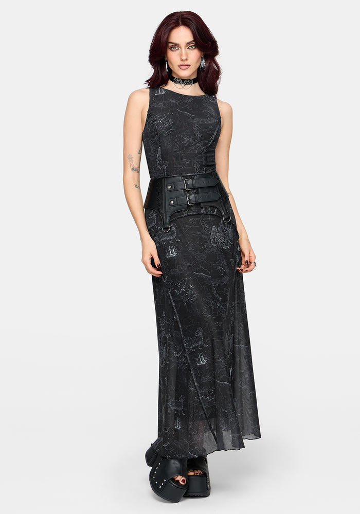Woman wearing a black printed sleeveless dress with a belt on a white background