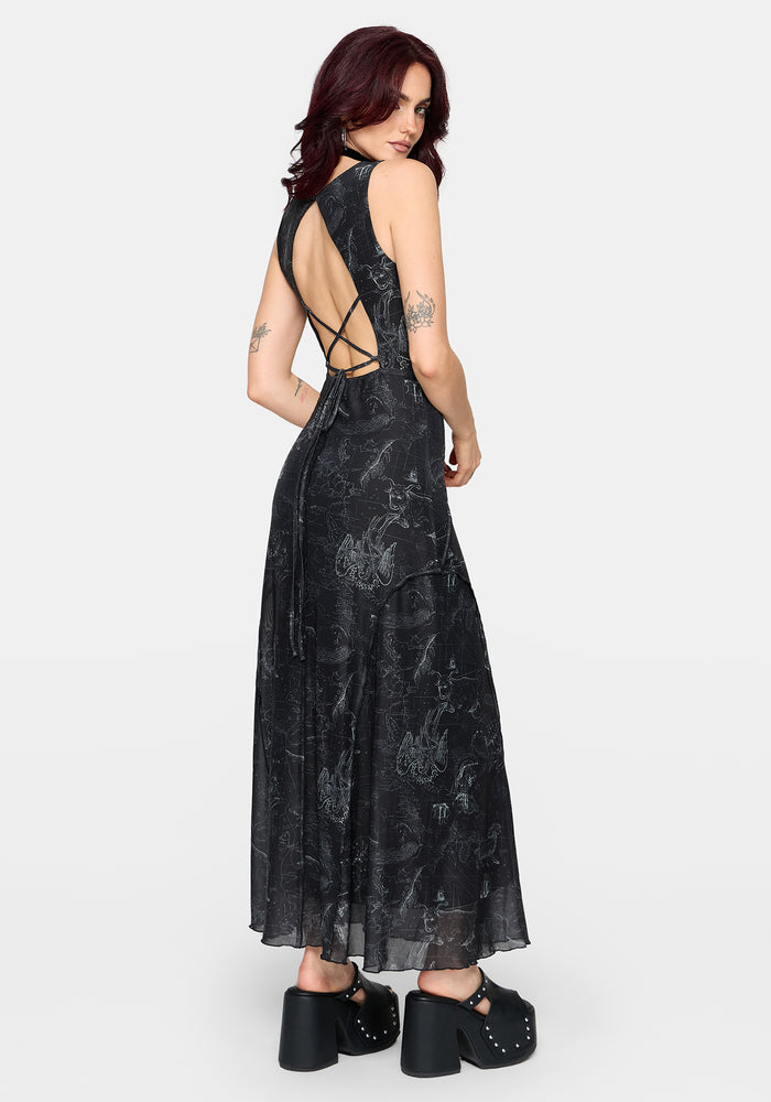 Woman wearing a black printed dress with criss-cross back design on a white background