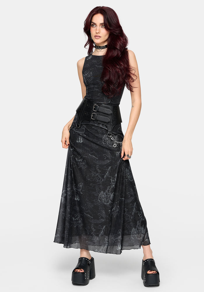 Woman wearing a black printed sleeveless dress with a belt on a white background