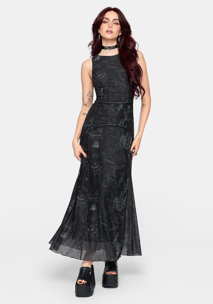Woman wearing a black printed sleeveless dress with a belt on a white background