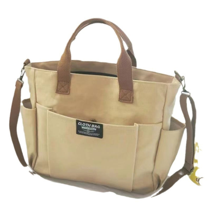 Canvas work bag product view showing the exterior, front pocket, top handles and adjustable strap for daily organization use.