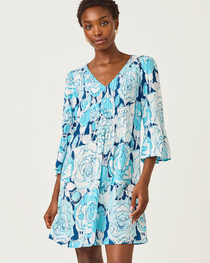 Woman wearing a blue floral dress on a white background