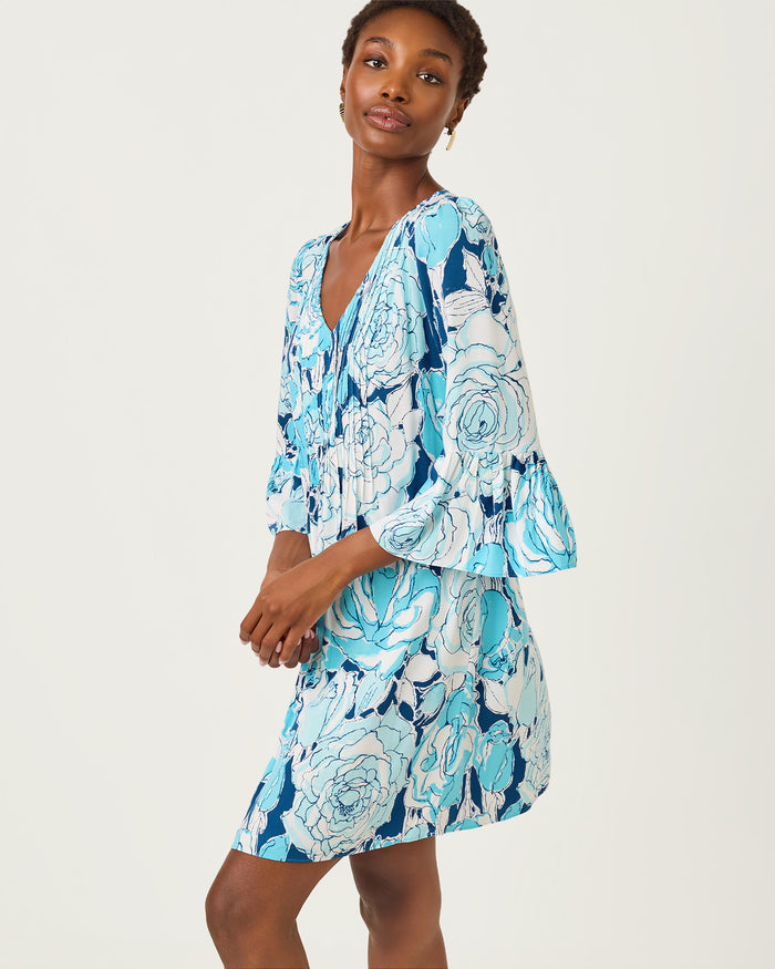 Woman wearing a blue floral dress on a white background