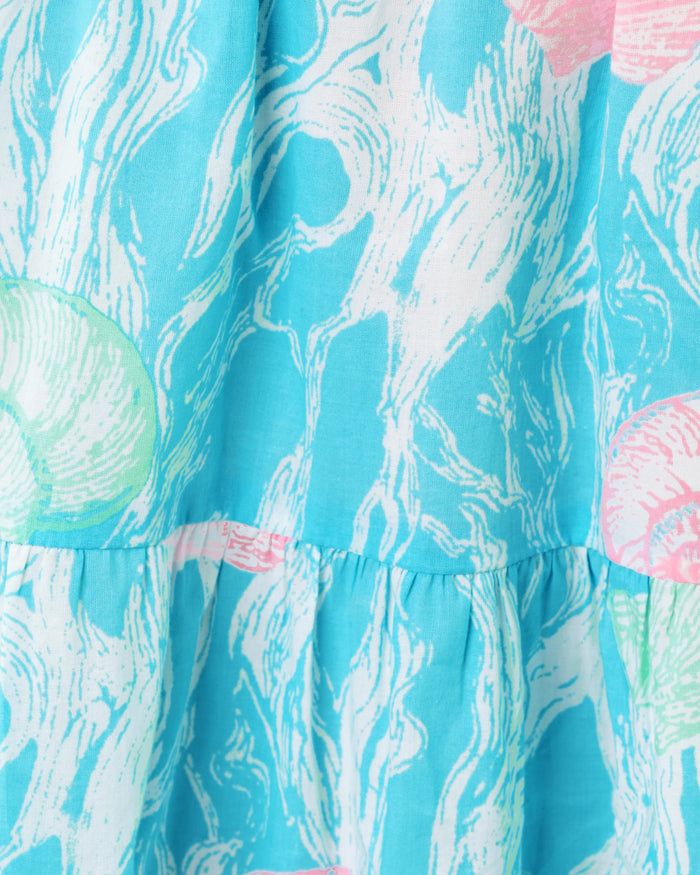 Blue dress pattern with teal and pink seashell details up close