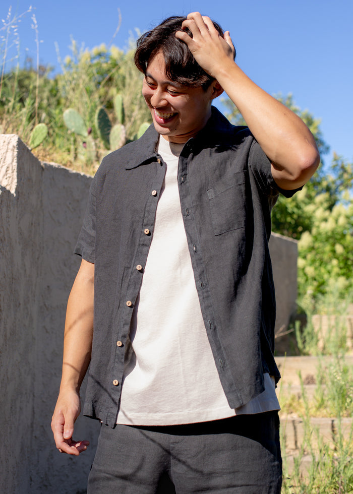 man wearing dark grey linen button down