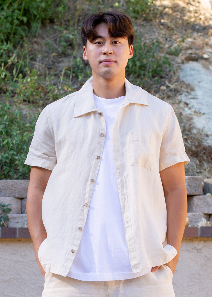 man wearing cream linen button down