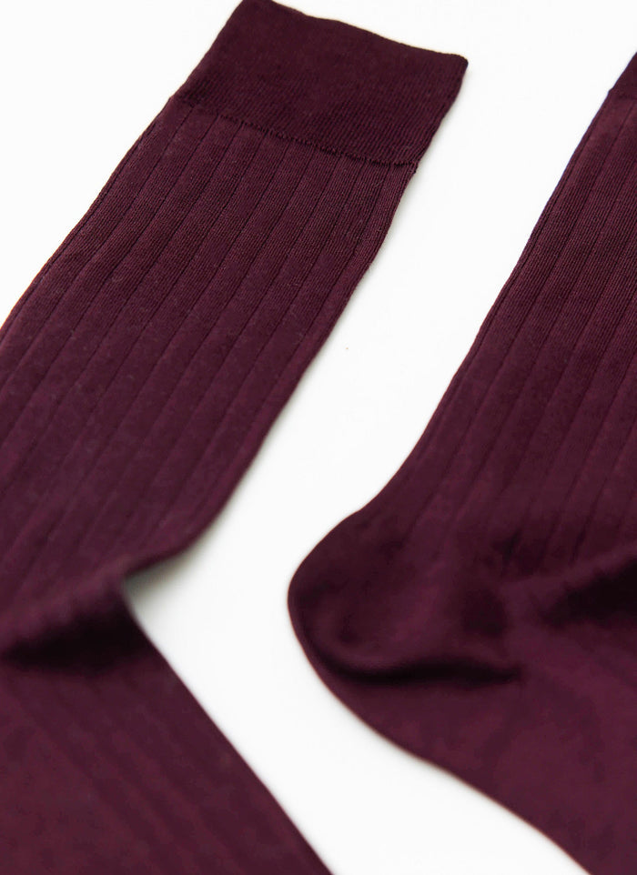 A close-up of the Percival Loafer Dress Socks in merlot, showing the fine ribbed cotton texture against a white background.