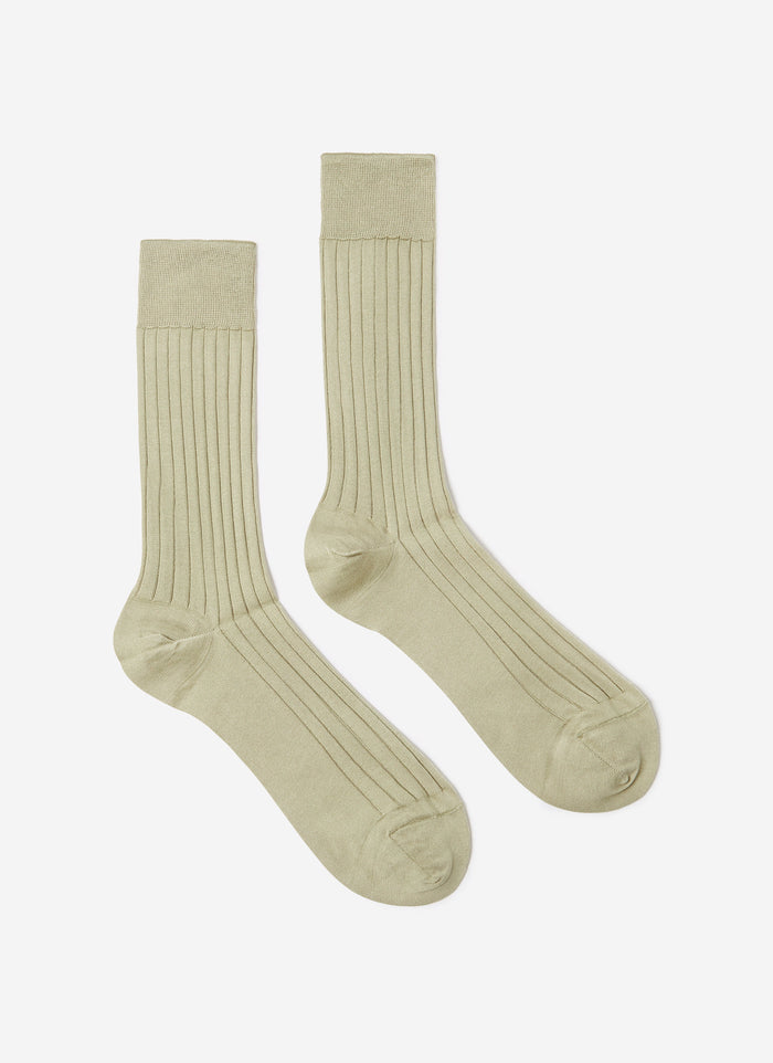 A flat lay of the Percival Loafer Dress Socks in sage green, showing the ribbed cotton texture.