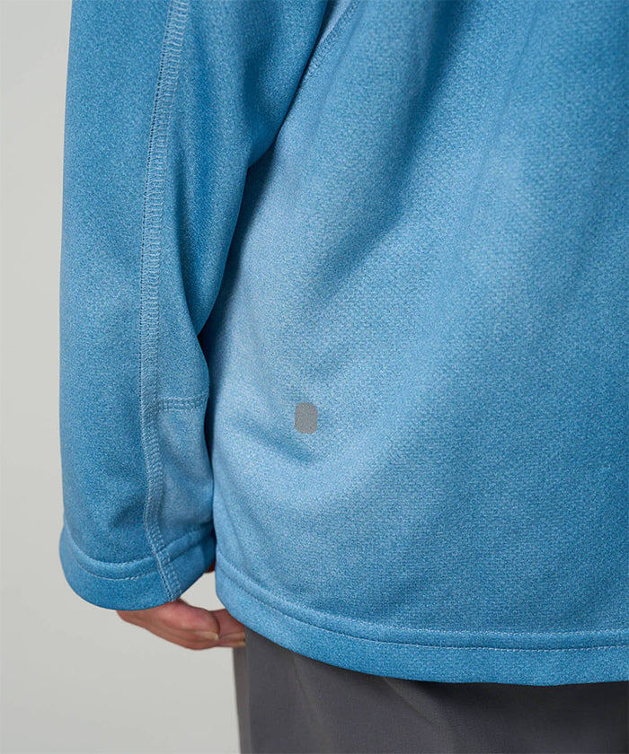 Close-up view of a Gramicci L/S 1st Layer in blue tie-dye on a light-tone background.