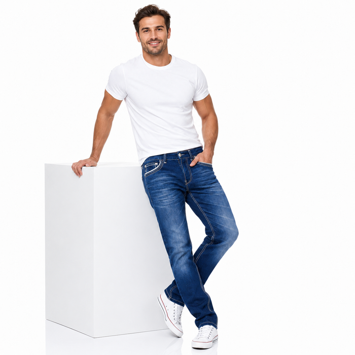 Men's straight fit jeans in blue shown on a male model in a relaxed studio pose beside a simple white display block.