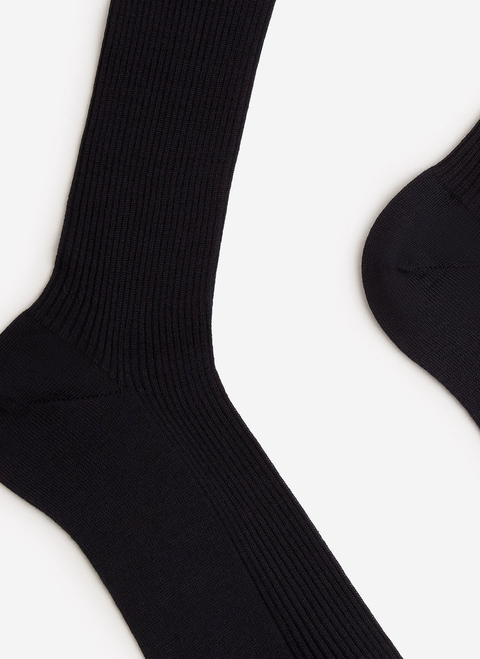 A close-up of the Percival Merino Wool Socks in navy, showing the detail of the ribbed knit against a white background.