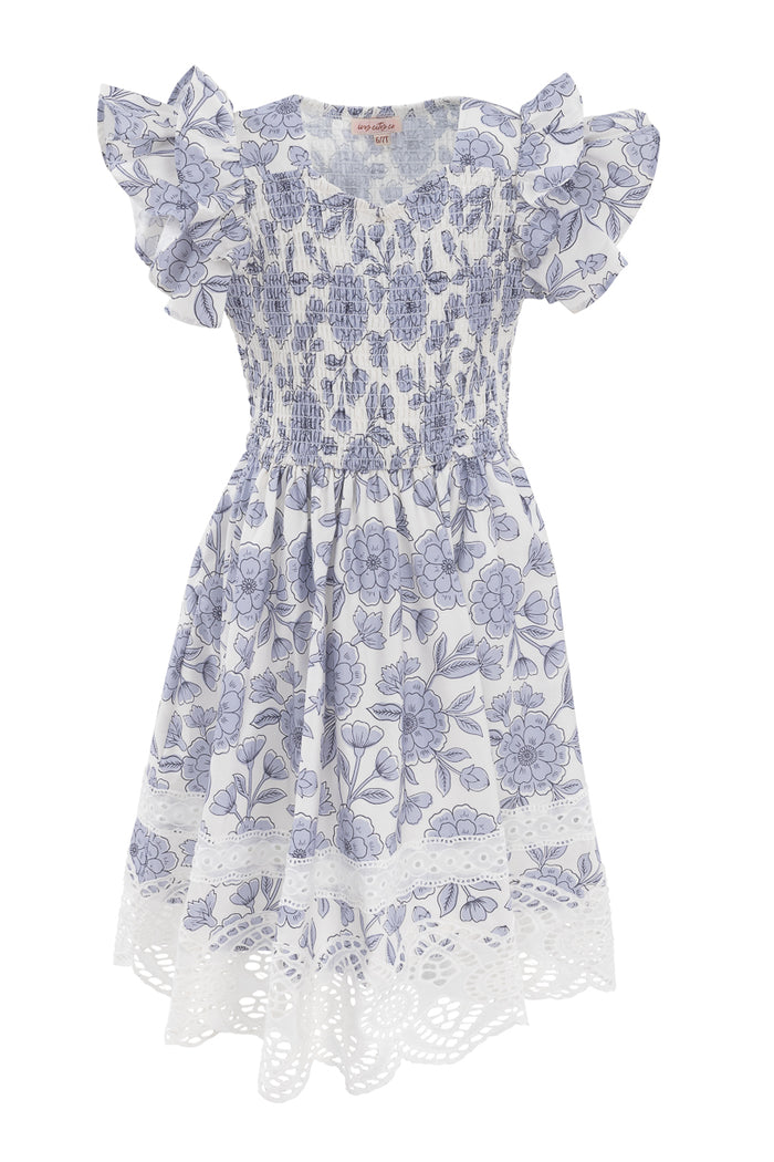 The Mini Hattie Dress in Blue Floral by Ivy City Co features short ruffled sleeves, a shirred bodice, flared skirt, and lace cut-out hem—perfect for sunny days with its playful pattern and charming cotton style.