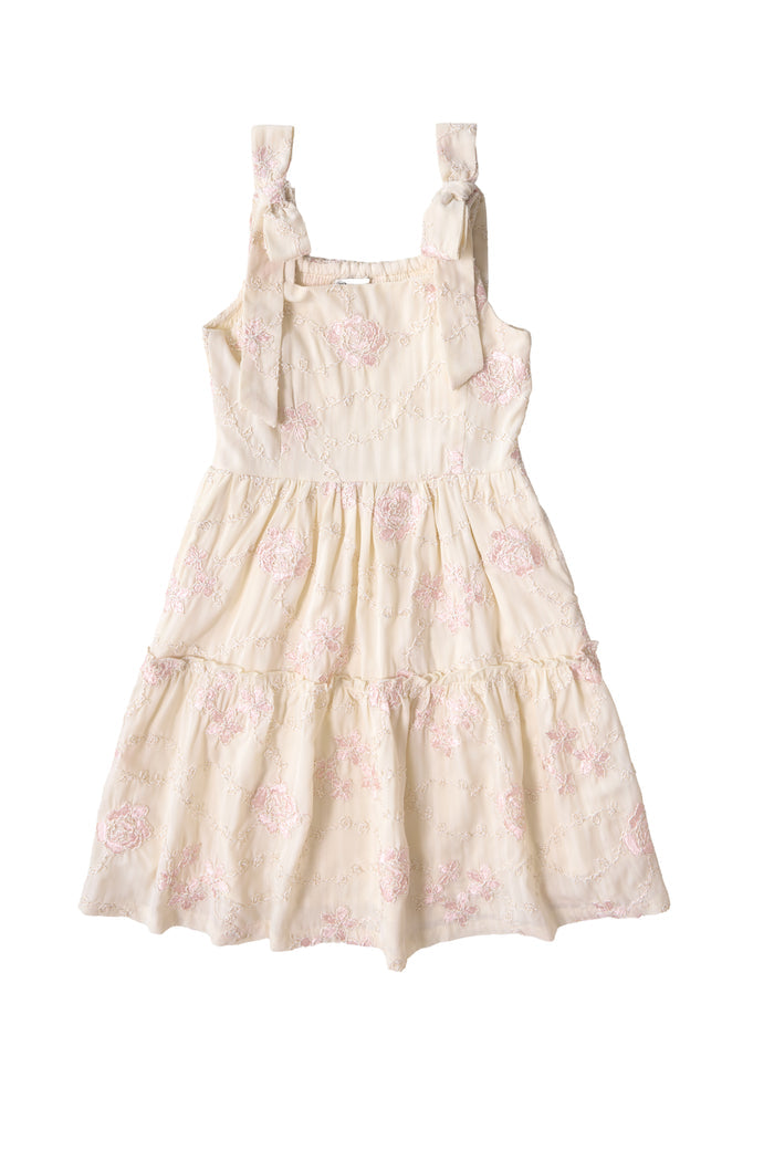The Ivy City Co Mini Tara Dress in Gilded Rose Stripe features a tiered skirt, subtle pink floral embroidery, and wide shoulder straps tied into bows—shown here for girls against a white background.