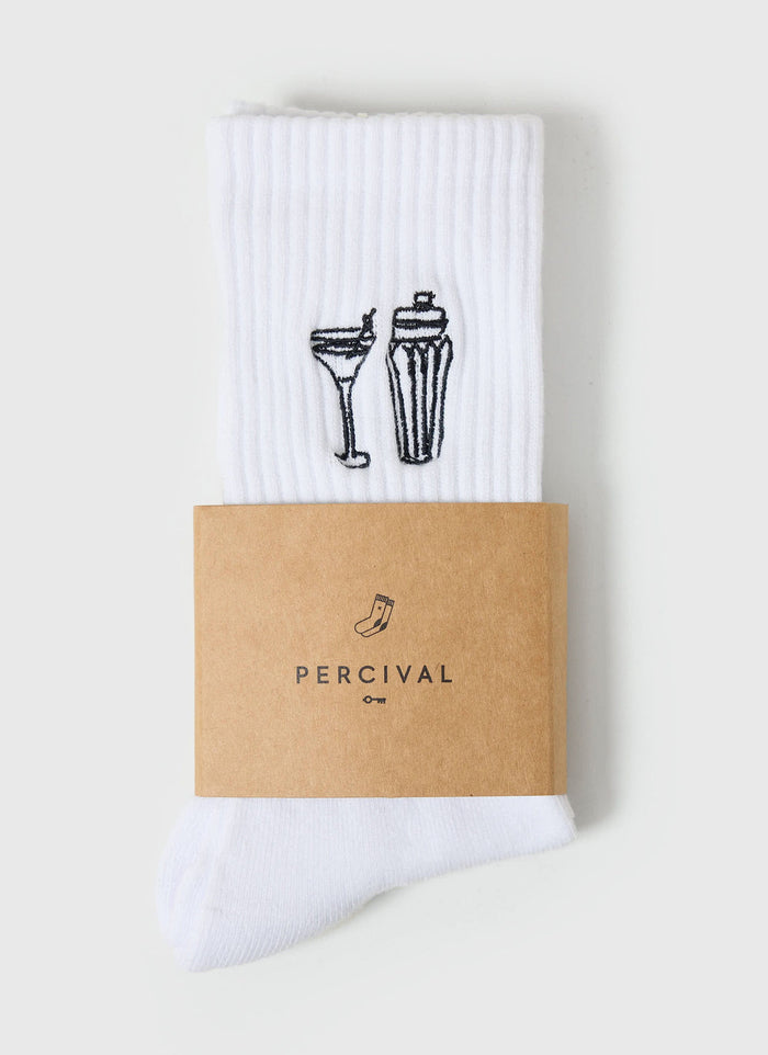 A pair of white ribbed Percival socks with black Mixologist embroidery of a cocktail glass and shaker, in branded packaging.