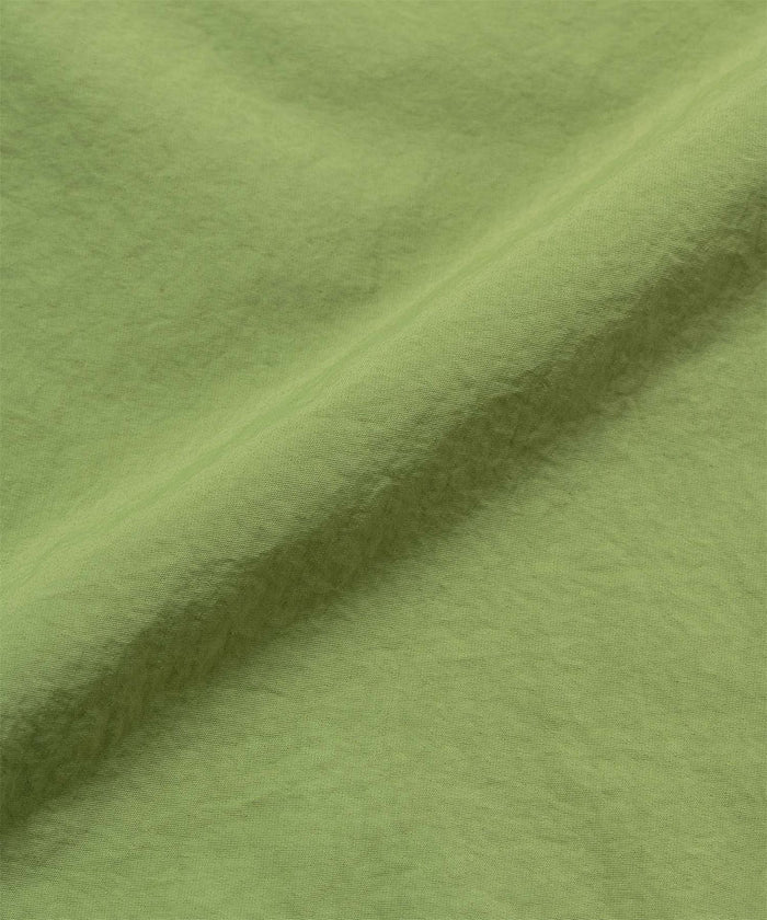 Jade green colored Gramicci Nylon Block Shorts fabric swatch.