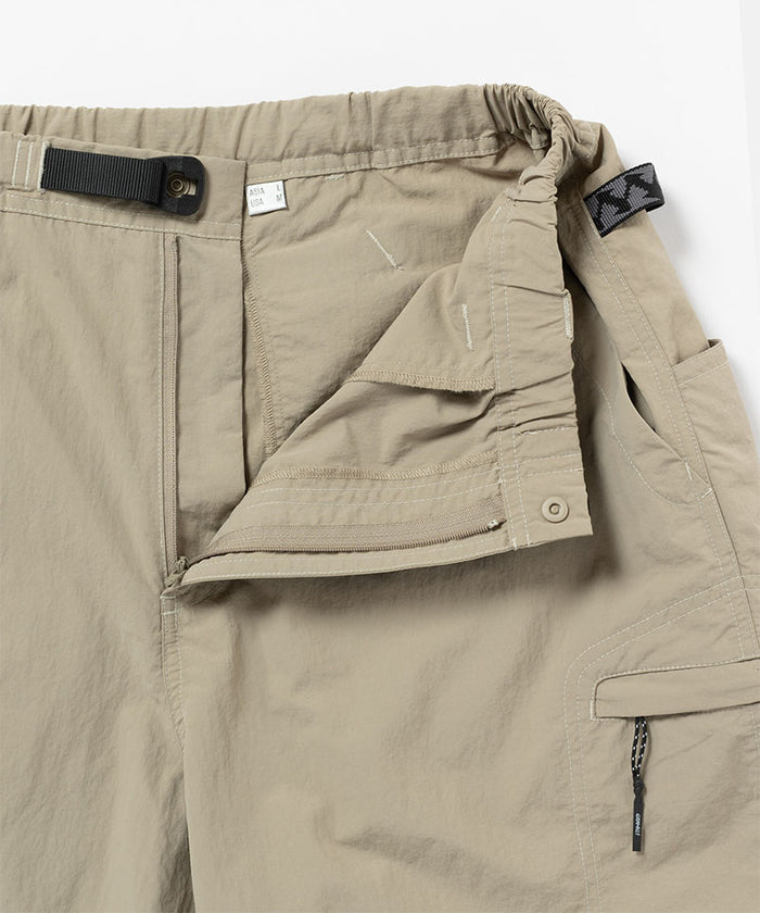 Close-up view of milk tea colored Gramicci Nylon Cliff Short on a light-tone background.