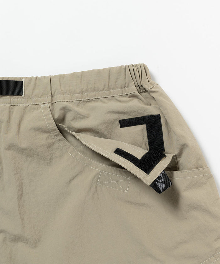 Close-up view of milk tea colored Gramicci Nylon Cliff Short on a light-tone background.