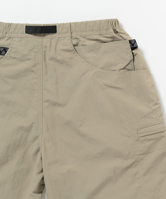 Back view close-up of milk tea colored Gramicci Nylon Cliff Short on a light-tone background.