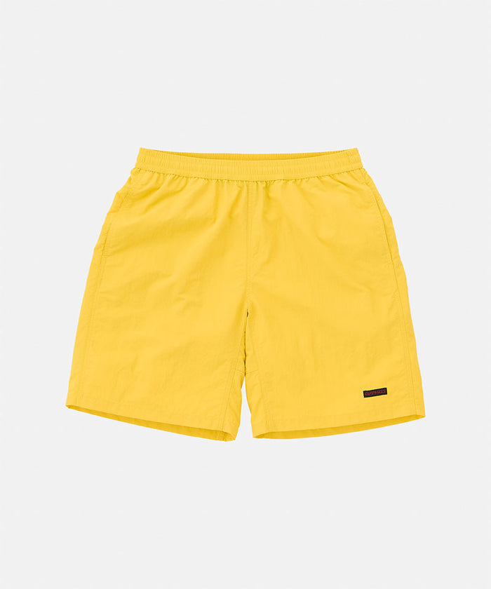 Banana colored Gramicci Nylon Reef Short against a light-tone background.