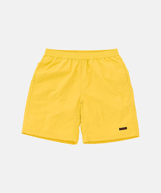 Banana colored Gramicci Nylon Reef Short against a light-tone background.