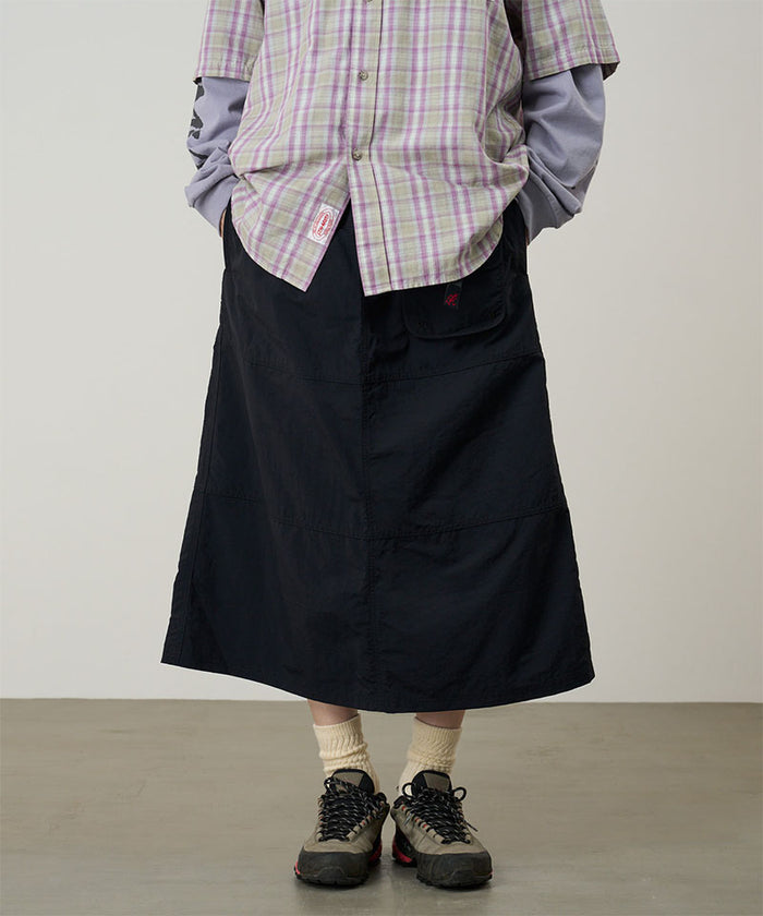 Model wearing a Gramicci black Nylon Utility Skirt against a light-tone background.
