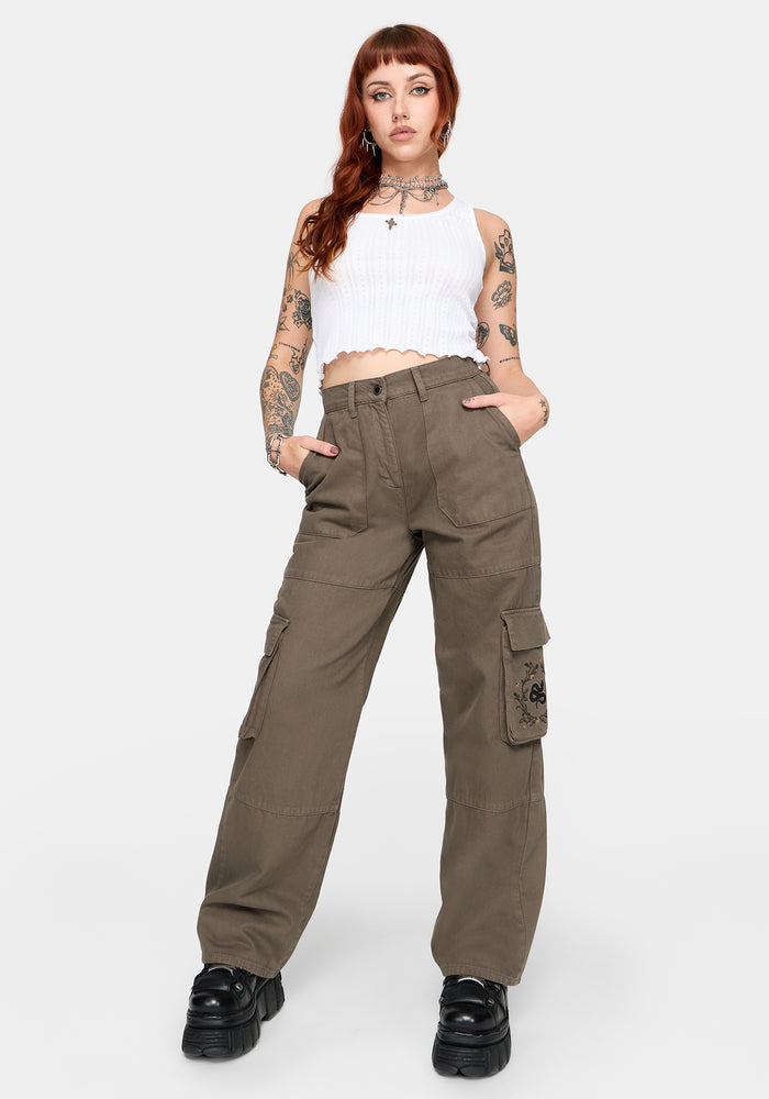 Woman wearing brown cargo pants on a white background