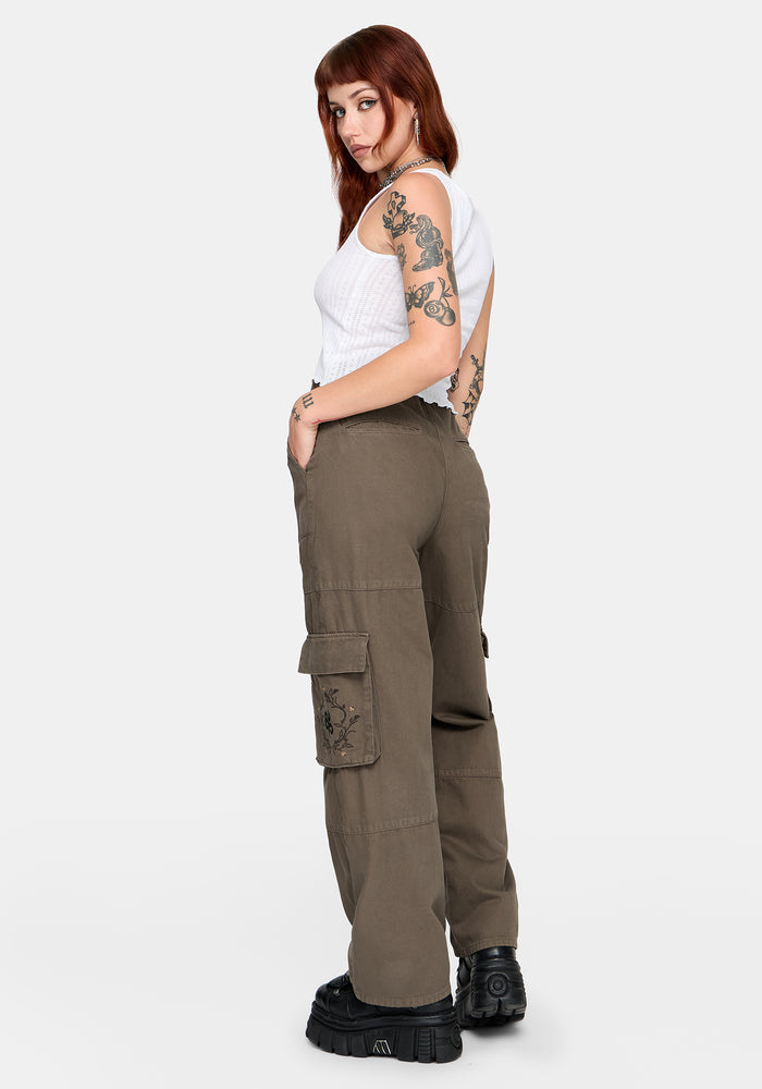 Woman wearing brown cargo pants on a white background