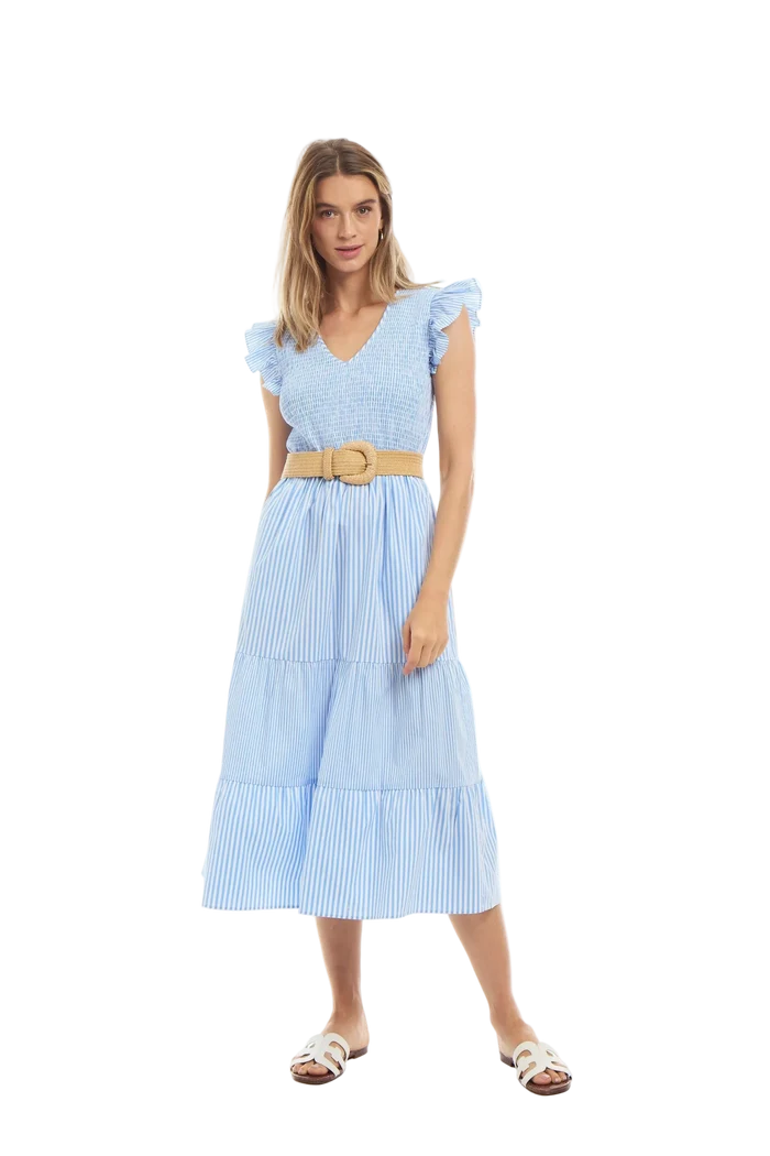 Woman wearing a light blue dress with a belt on a white background