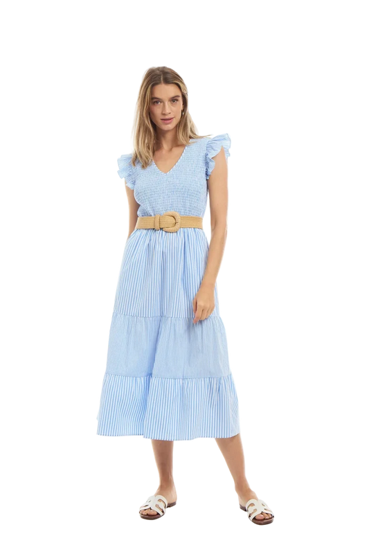 Woman wearing a light blue dress with a belt on a white background