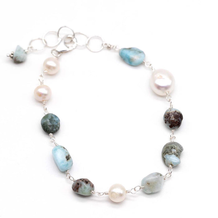 pearl and ammonite bracelet on flat lay