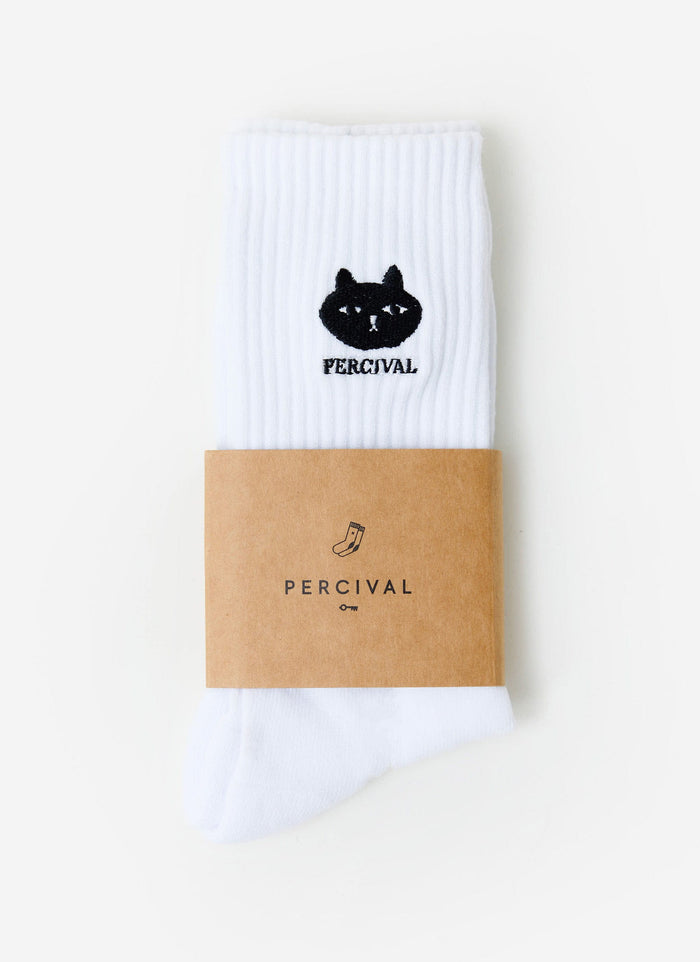 The Percival Perci Loaf socks in white, featuring the signature black embroidered cat logo, seen folded in their sleeve.