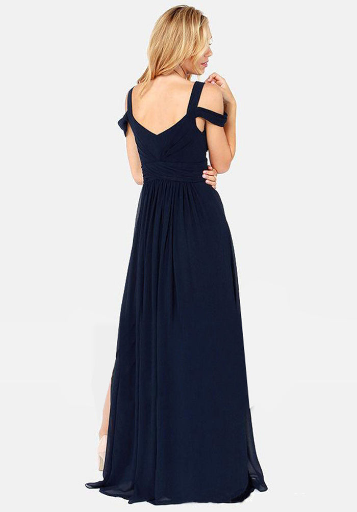 Close-up of the pleated maxi dress showing short sleeves, upper dress details and the Grecian-inspired styling of the design.