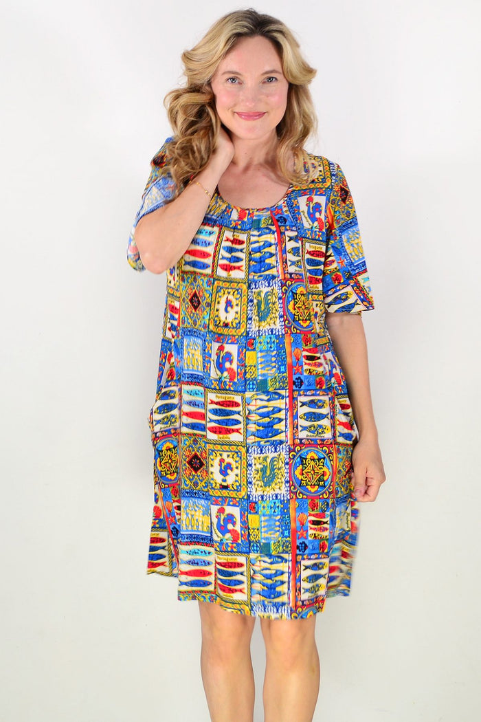 Portuguese short sleeve tunic dress by One Summer, lightweight fabric with a relaxed fit, displayed on a hanger.