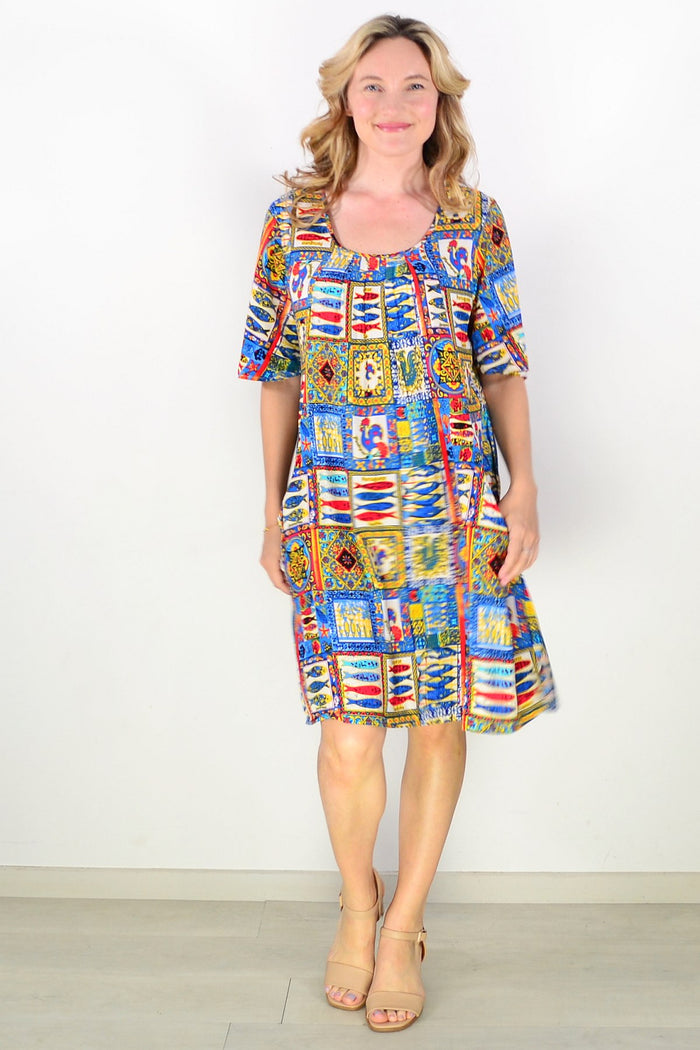 Portuguese short sleeve tunic dress by One Summer, featuring lightweight fabric and a relaxed fit, displayed on a hanger.