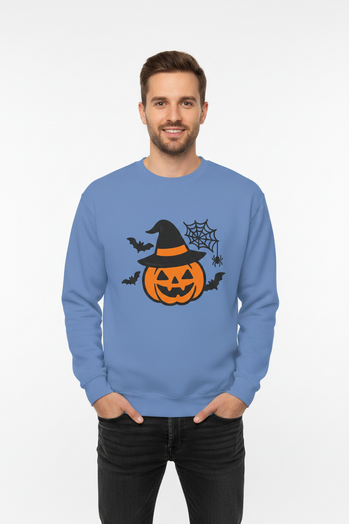 Flat lay of Halloween pumpkin sweatshirt in rust orange on wooden surface with autumn leaves
