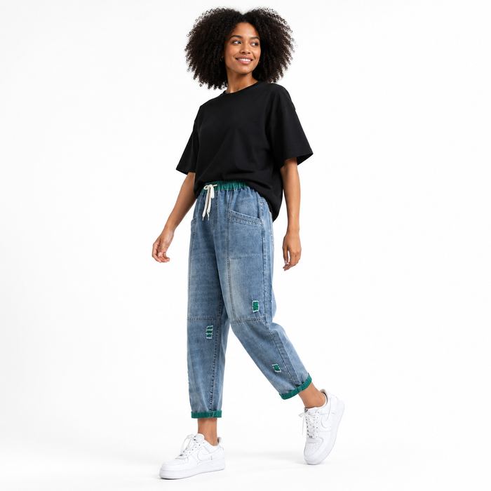Casual women's denim jogger pants with cotton denim construction, visible seam detail, and versatile everyday styling.