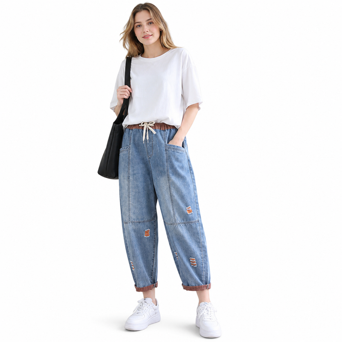 Distressed women's denim pants with a drawstring waistband, functional pockets, and a neat cropped silhouette.