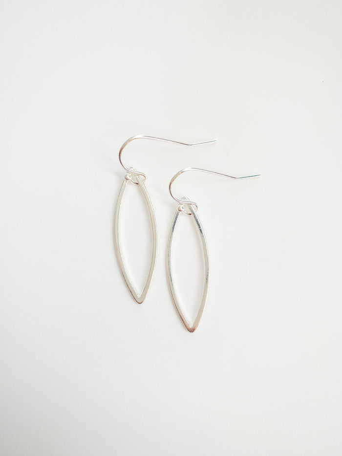 sady earrings in silver on flat lay