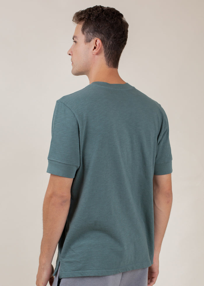 back of man wearing henley tee in pine green