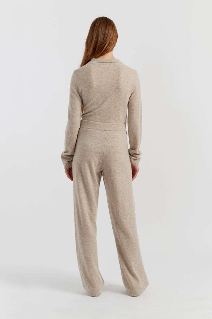 Woman wearing a beige jumpsuit on a white background