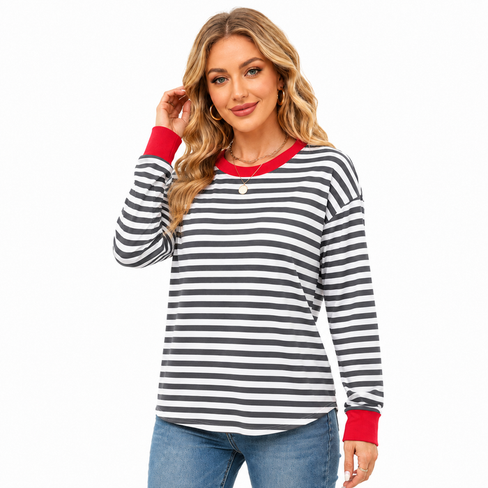Women's gray and white striped top with red neckline and cuffs, shown in an angled studio pose with blue jeans on pure white.