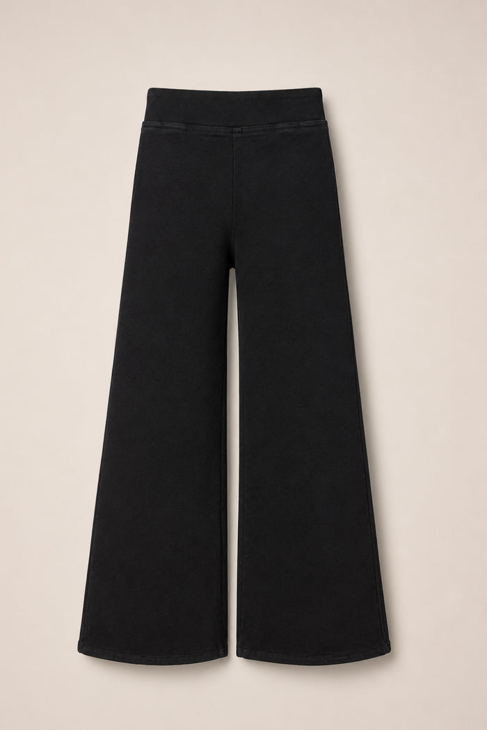 The Tyler Pants in Black by Ivy City Co are wide-leg cotton pants with an elastic waistband, shown flat on a neutral background. This minimalist style features a flared silhouette, providing an easygoing alternative to classic denim.