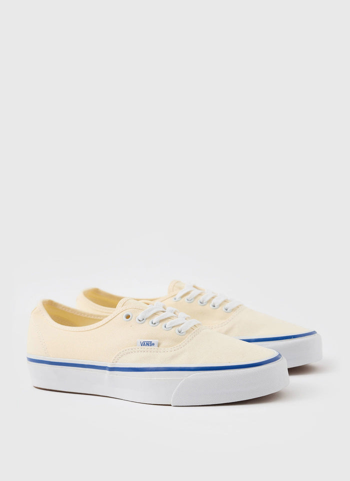 A pair of Vans Authentic 44 Premium trainers in off-white, shot against a clean white background for Percival.