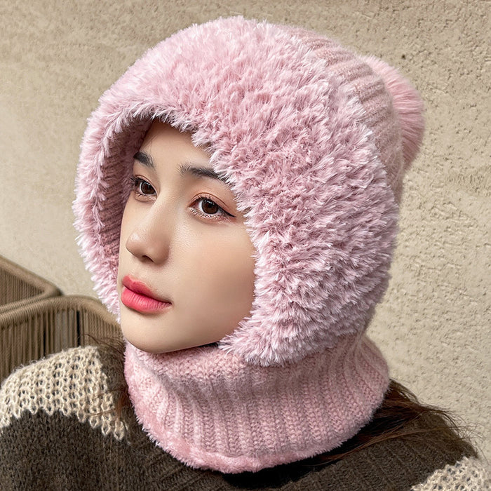 Person wearing a pink knitted hat and scarf against a beige background